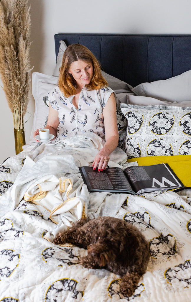 Lady in a bed reading 