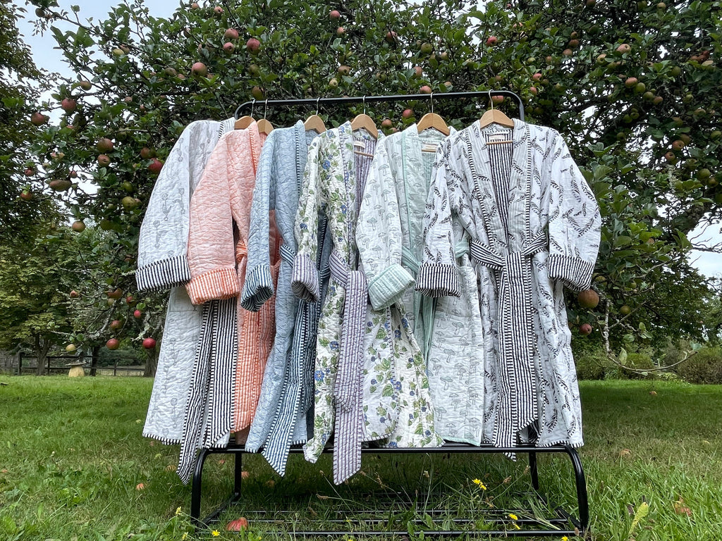 quilted dressing gowns on a clothes rail in the garden 