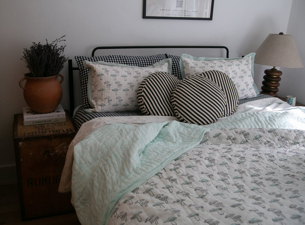 bed made up with block printed bedding 