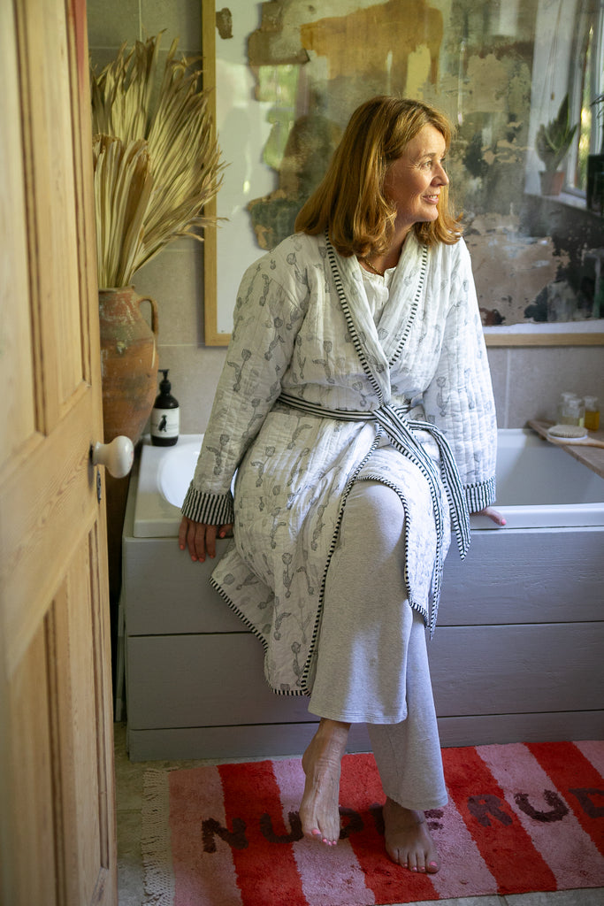 lady sitting on edge of a bath 