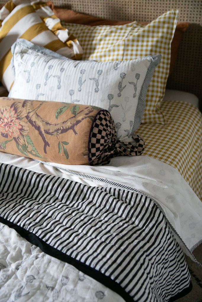 tulip printed pillow on a bed