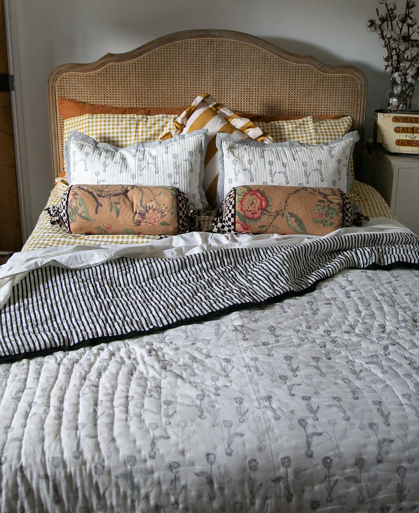 bed with block printed bedlinen in a black and white ulip design 