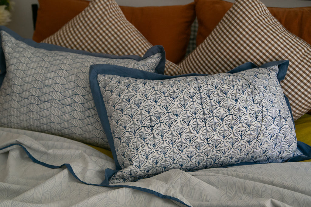 block printed cushions on a bed