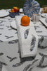 a feather napkin on a tale with an orange 