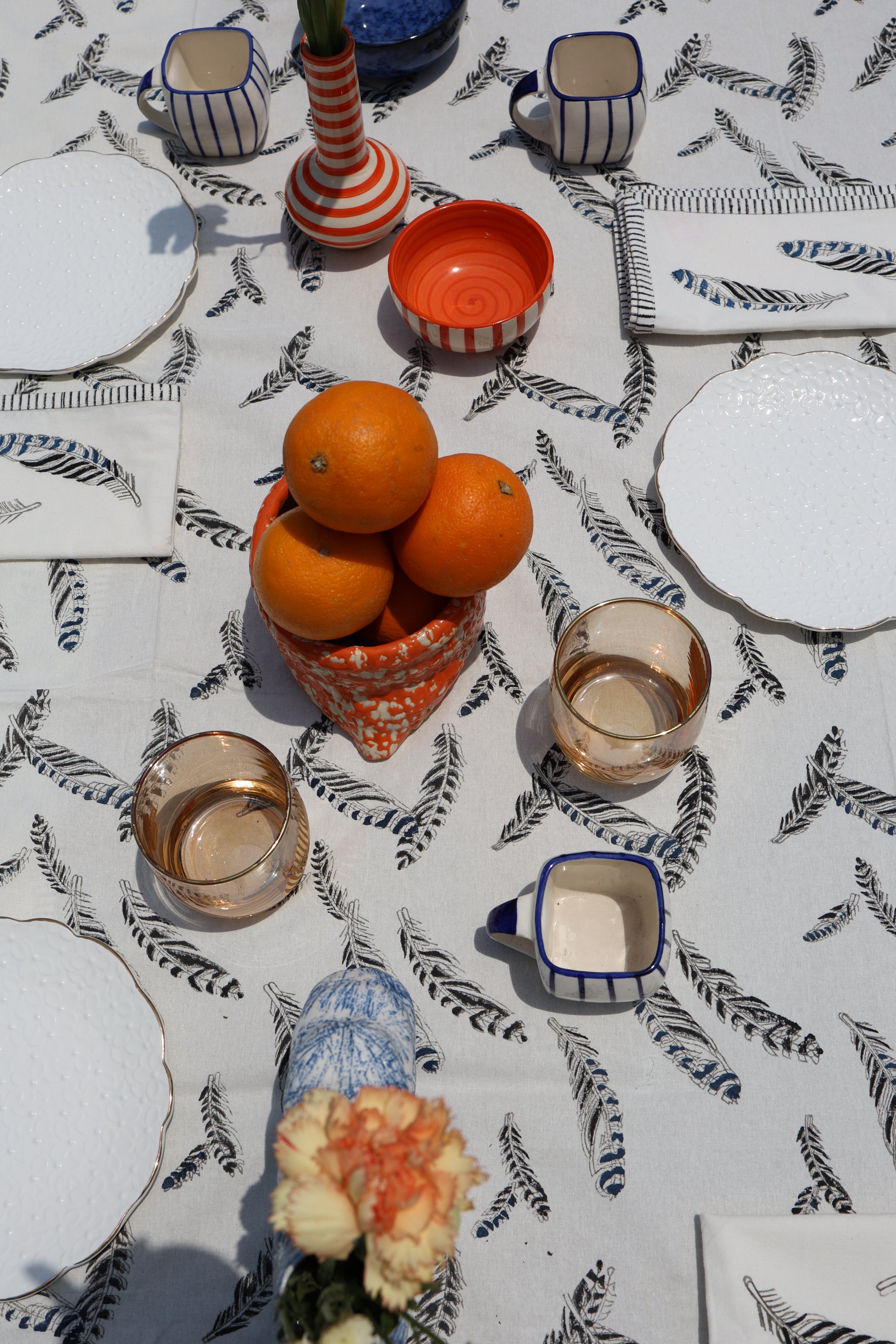 close up of a tablescape with a jay feather printed tablecloth 