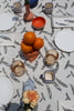 close up of a tablescape with a jay feather printed tablecloth 