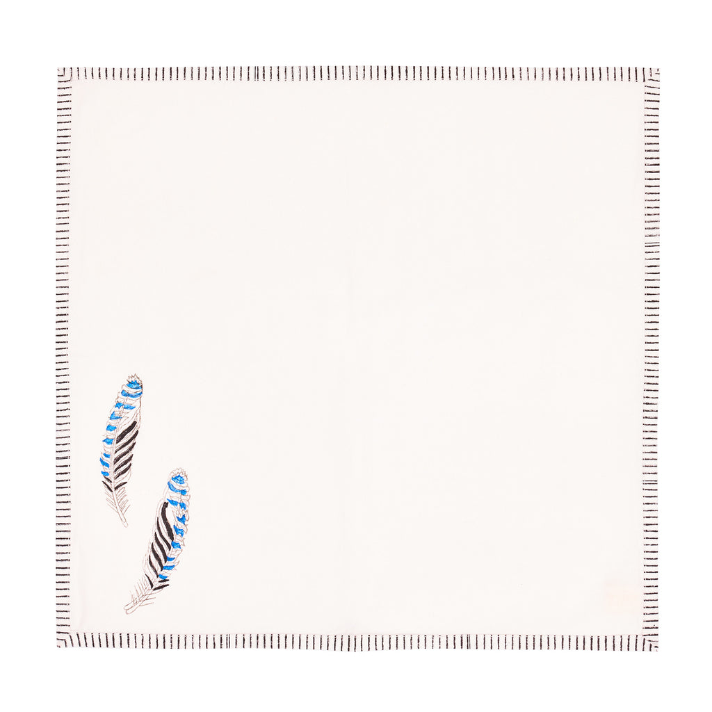 a block printed napkin with a feather motif