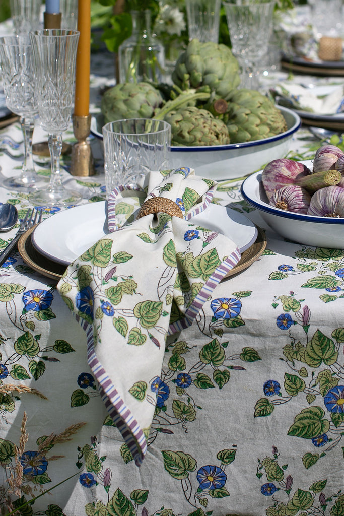 block printed napkin on a plate with a bowl of garlics