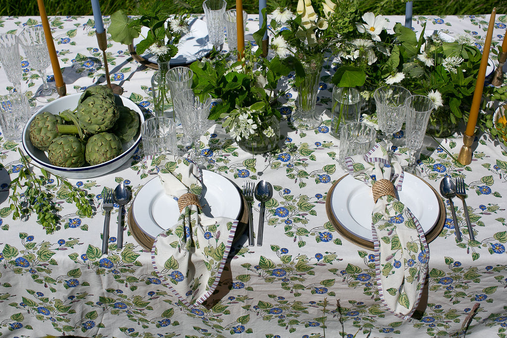 close up of a block printed tablecloth and matching napkins in a Morning Glory pattern 