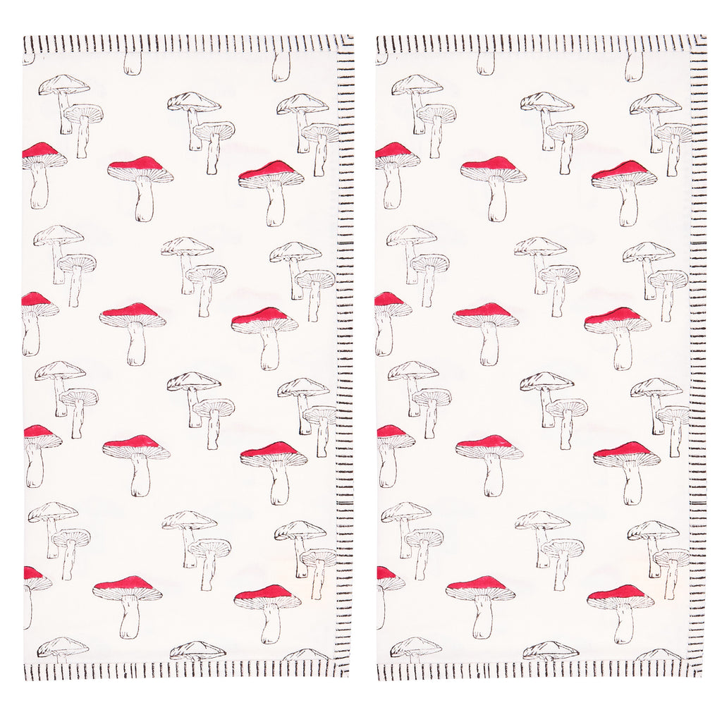 two folded napkins with a red and white mushroom print