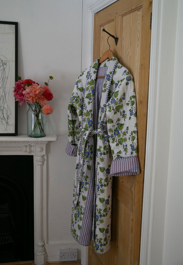 Block printed Robe in a Morning Glory design hanging from the back of a bedroom door