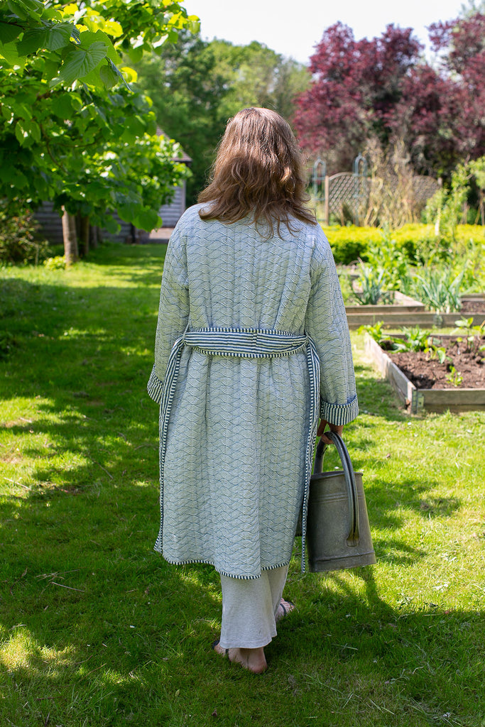 lady walking in the garden wearing a blue block printed robe 