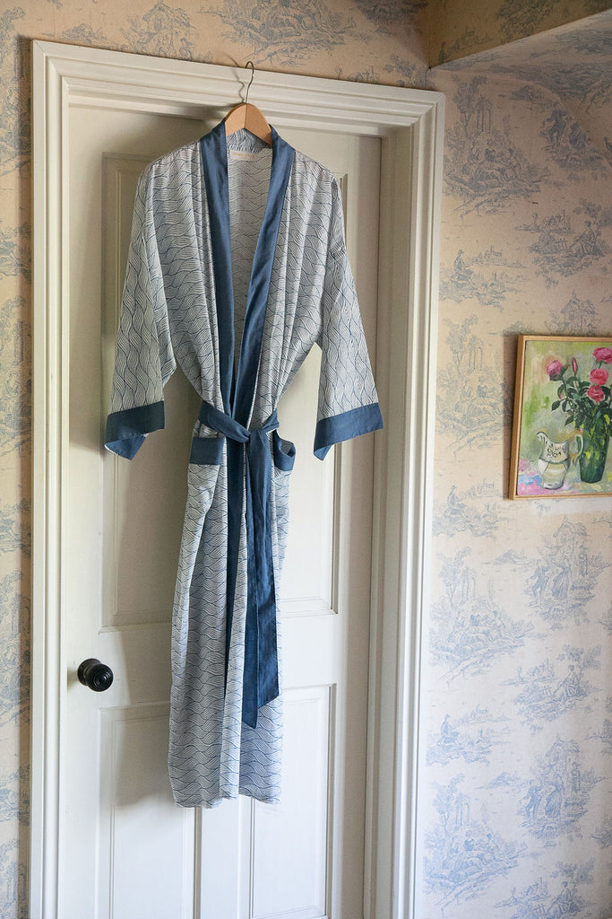 blue block printed kimono on a hanger on the back of a bedroom door