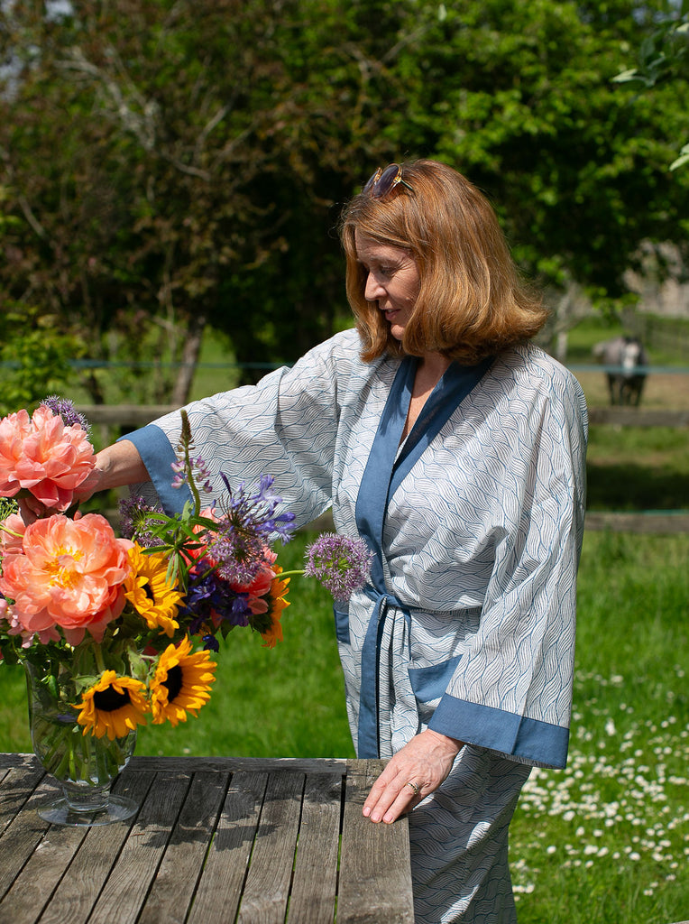 lady flower arrangeing wearing a blue block printed cotton kimono