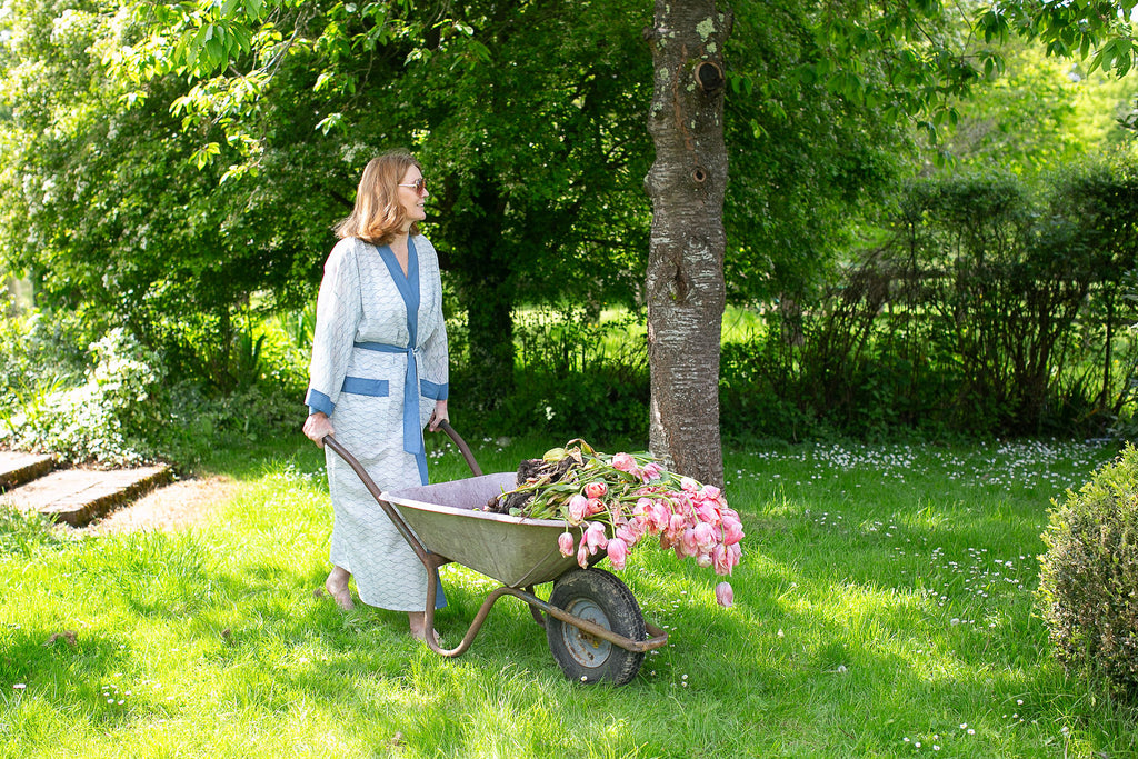 lady pushing a wheelbarrow wearing a block printed cotton kimono