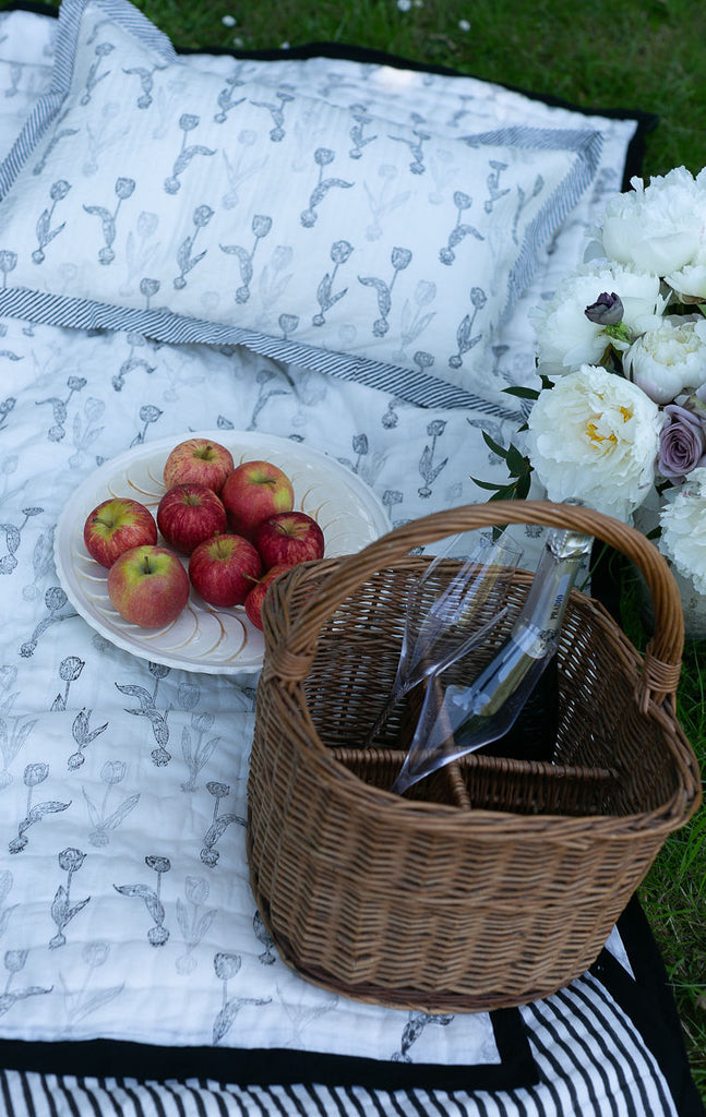 tulip block printed pillow on a picnic blanket 