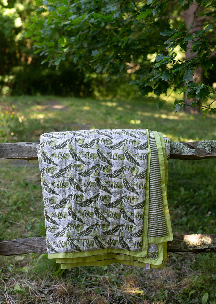 block printed quilt on a fence 