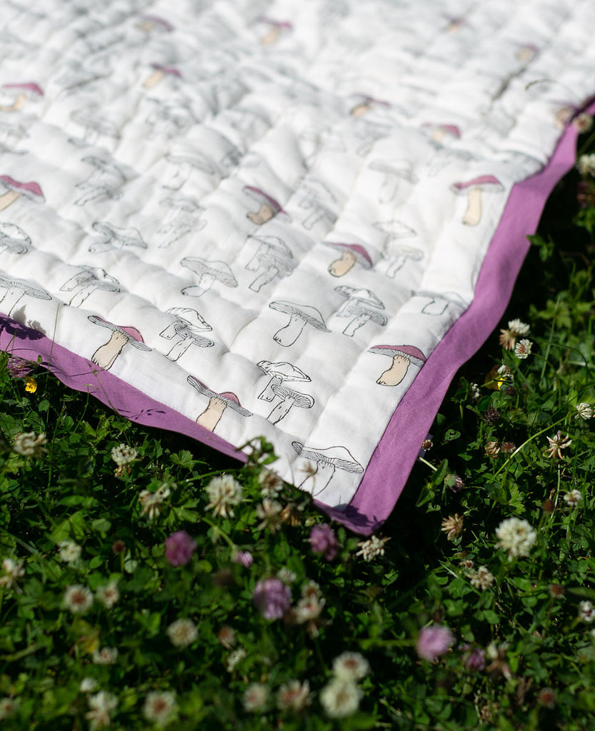 detail of a mushroom printed quilt in the garden 