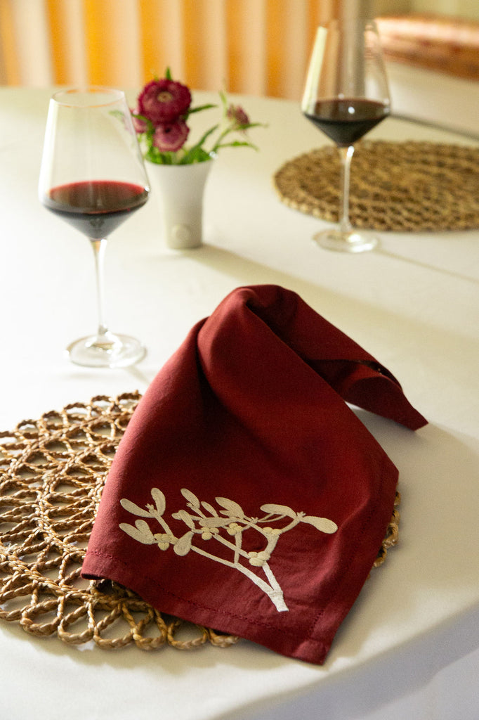 table with glasses of wine and a red napkin