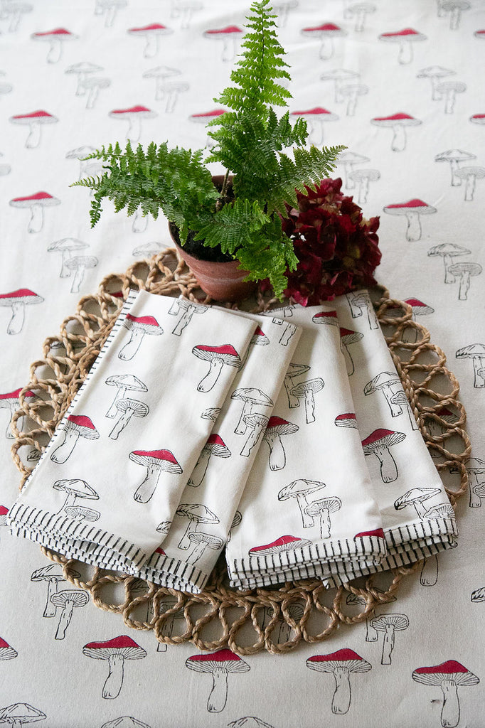 set of four napkins printed with red and white mushrooms 