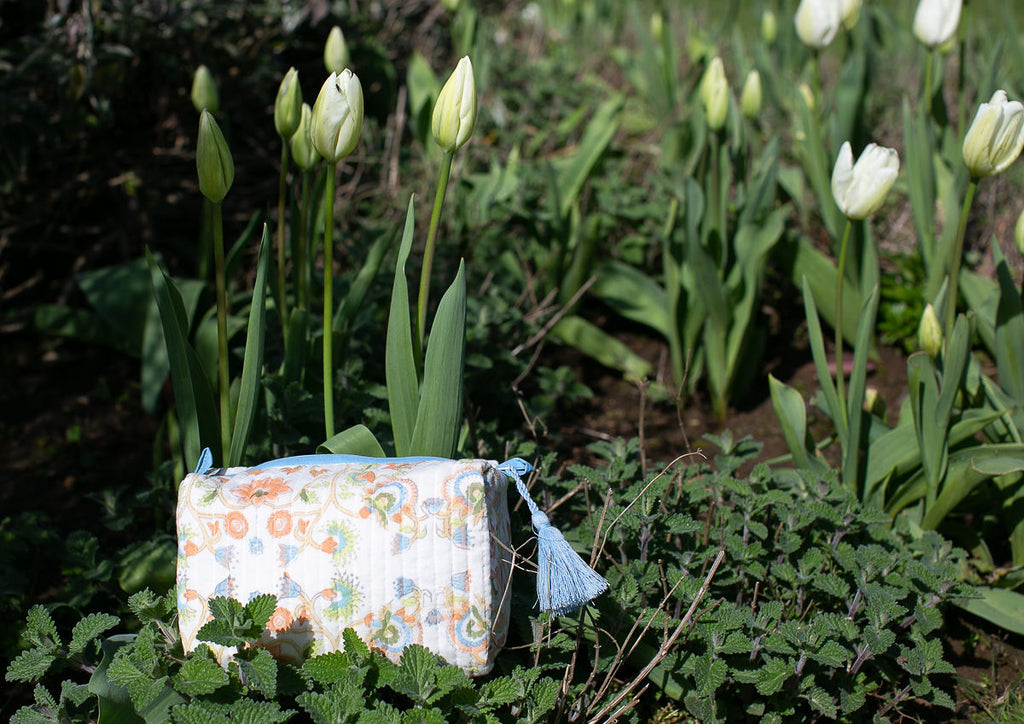 block printed wash-bag in a flowerbed with tulips