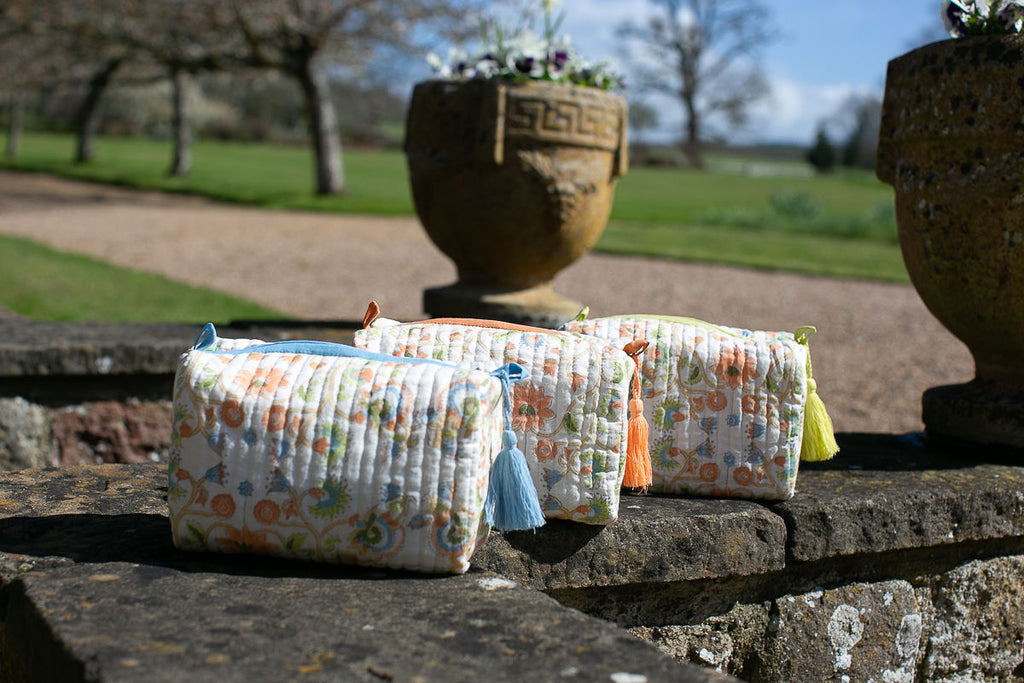 3 block printed wash bags on a stone wall