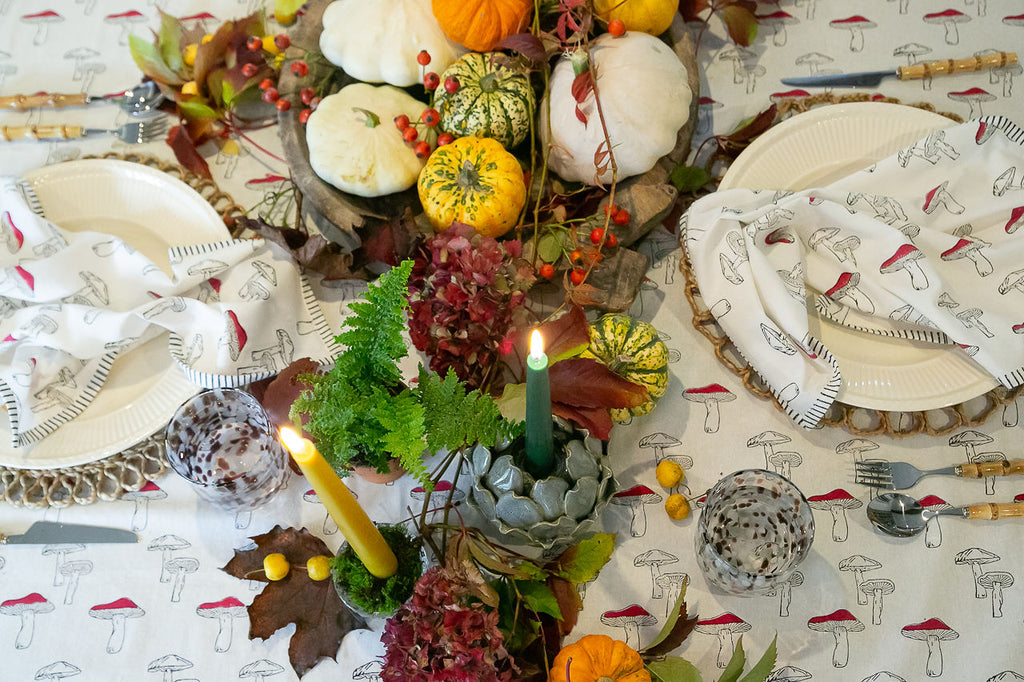 bird's eye view of an autumnal table-scape with a mushroom print tablecloth